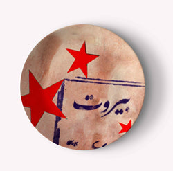 Plate that has red stars and Beirut written in Arabic